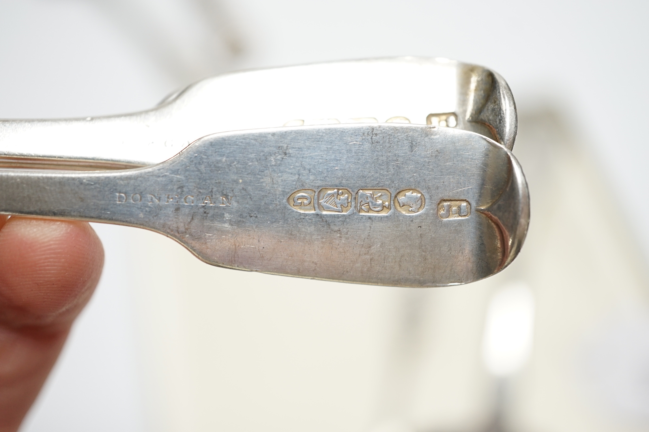 A William IV silver fiddle pattern sauce ladle, London, 1831 and six other assorted silver spoons.
